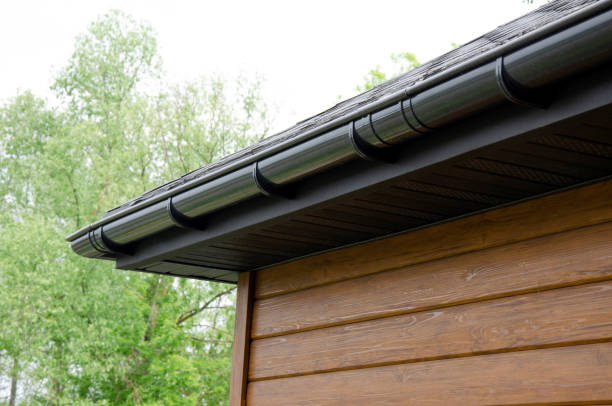istock Gray plastic gutter system on roof overhang close up 2145868570
