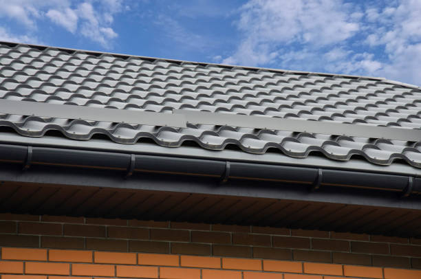 istock Plastic gutter system with metal roof tile against blue sky 2145868578