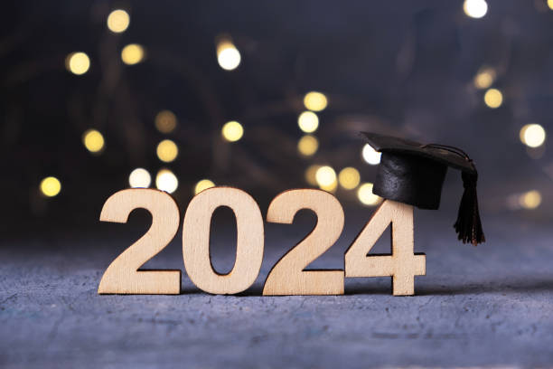 istock Class of 2024 concept. Number 2024 with graduated cap and bokeh lights. 2145888946