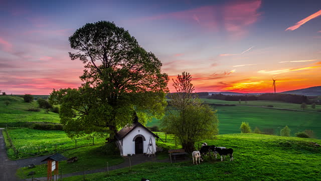 Rural landscape with small chapel at sunset