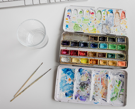 An old paint box on a desk