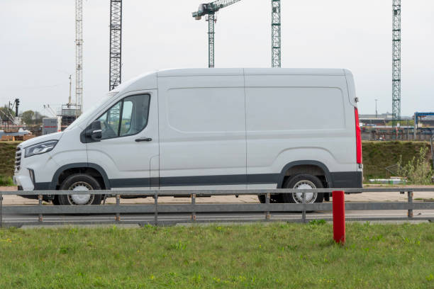 istock White delivery truck stands in front of a large construction site 2145918285