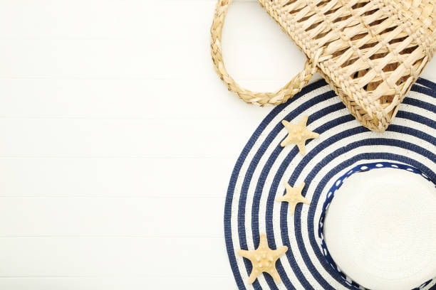istock Summer straw hat with bag and starfishes on white wooden table 2145922959