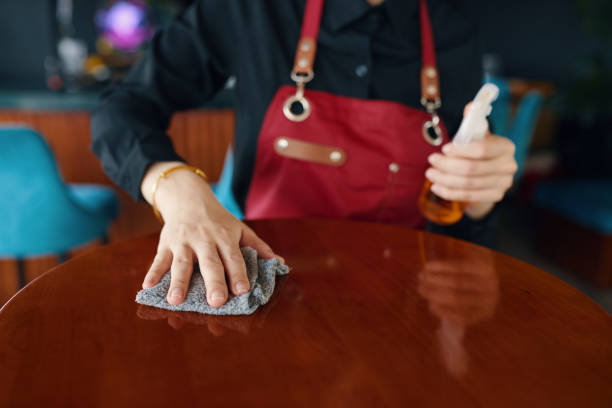 istock Cafe Waiter Polishing Tables 2145924012