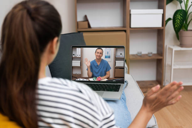 istock Smiling doctor greeting patient via video call, representing convenient and friendly telehealth services 2145928286