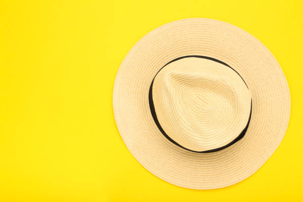 istock Summer straw hat on yellow background 2145936090