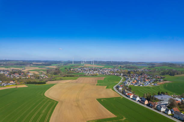 istock small village with a wind turbines on a horizon (aerial) 2145940820