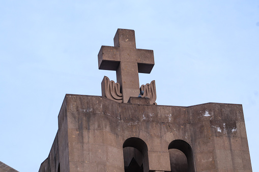 Cross on an ancient stone temple