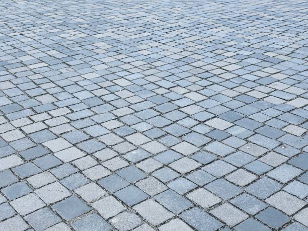 istock gray paved road from concrete pavers 2145993838