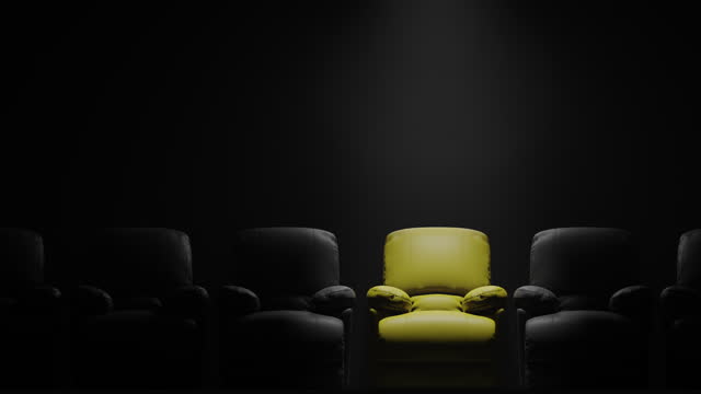 Yellow sofa Seat in front of black wall with spotlight