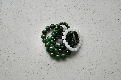 green and white bracelet on the table