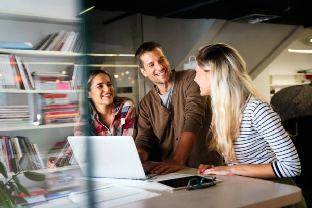 Group of young multi-ethnic startup business team collaborating on project in modern office