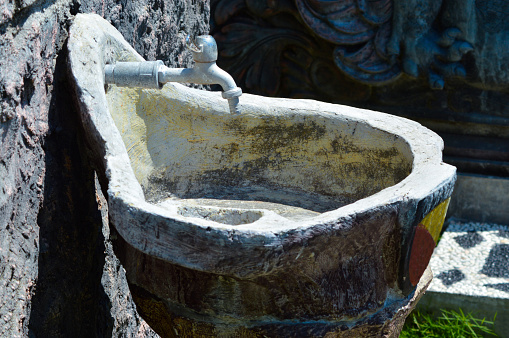 Close-Up Side View Of Artistic Concrete Outdoor Sink Building In The Garden