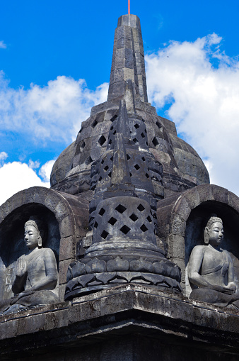 Low Angle Portrait View Of The Tiered Stupa Building And Relief Sculptures Of Buddha Samadhi At The Buddhist Temple In Banjar Tegeha, Buleleng, Bali, Indonesia