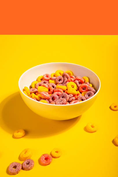 istock Bowl of colorful cereal corn rings on yellow table. Breakfast concept. 2146141113