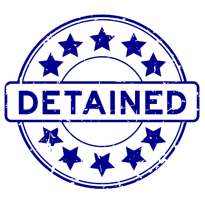 Grunge blue detained word round rubber seal stamp on white background