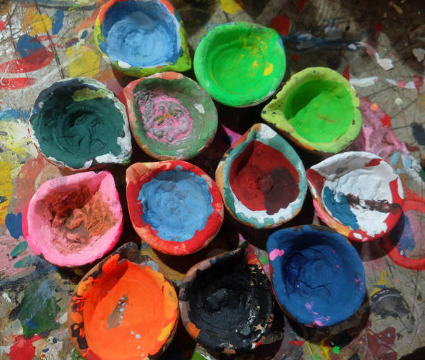 istock Different bright multicolors that can be painted by hand for entertainment. Beautiful Clay box with paint of different colors are standing on the ground. 2146149860