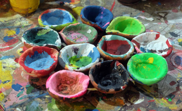 istock Different bright multicolors that can be painted by hand for entertainment. Beautiful Clay box with paint of different colors are standing on the ground. 2146154027