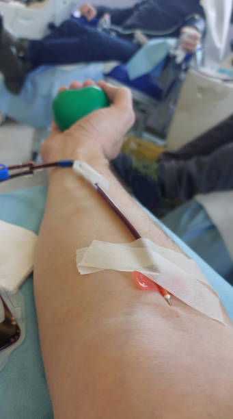 istock volunteer blood donor during the transfusion with the needle inserted into the arm 2146223912