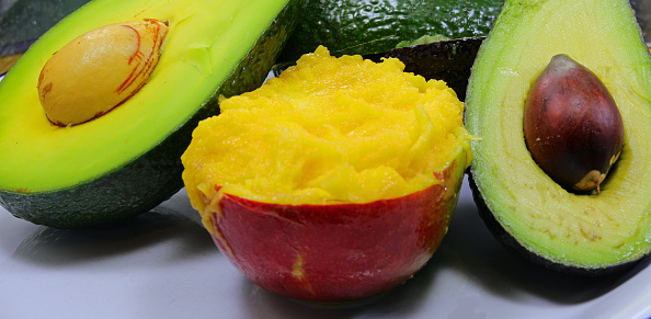 Ripe tropical fruits with avocado and juicy mango flesh perfect for a healthy eating and wellness concept