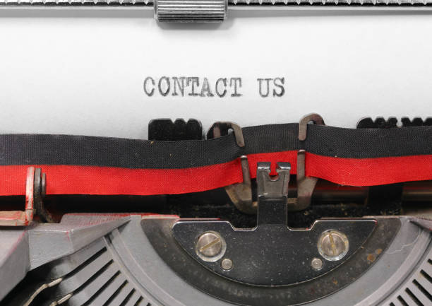 istock text CONTACT US with Black ink on white paper in the typewriter  ideal for website 2146243514