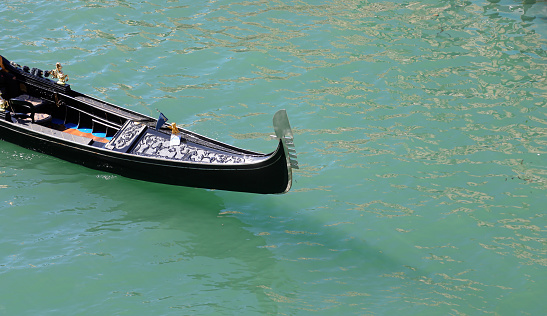 Bow of a gondola the iconic tourist boat sailing the Grand Canal in Venice Italy without people.