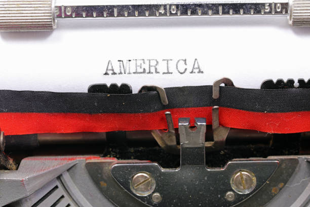 istock Typewritten AMERICA in black ink on white paper with an antique typewriter 2146254030