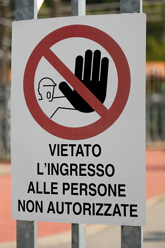 Construction site sign with the writing in Italian meaning Entry to unauthorized persons prohibited for personal safety