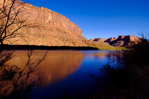 Green River and Canyon Reflections - Scenic view with rugged red sandstone canyons.  Canyonlands, Utah, USA
