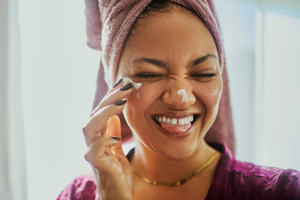 A woman enjoying a moment while doing her daily skin-care routine