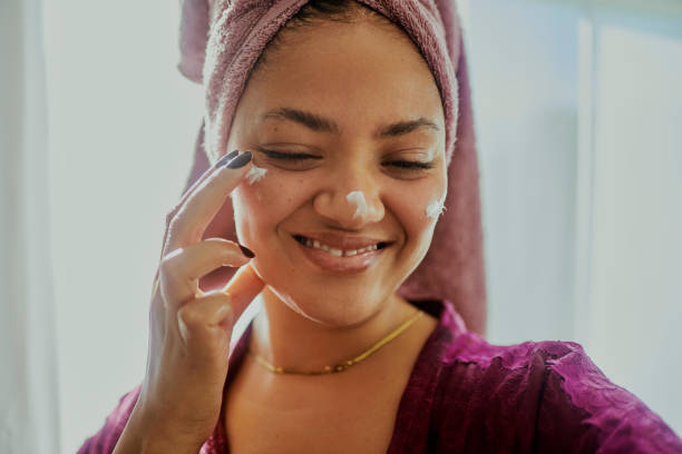istock A woman enjoying a moment while doing her daily skin-care routine 2146317105