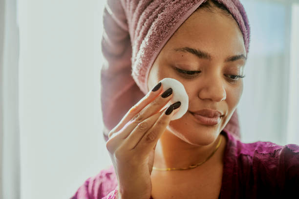 Skincare Routine: Woman Cleansing Face with Cotton Pad