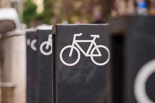 The row of bike park metal racks with bike icons, installed in the city