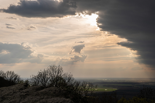 View from the Somló Hill with dark clouds. There are sunbeams filtering through dense clouds.