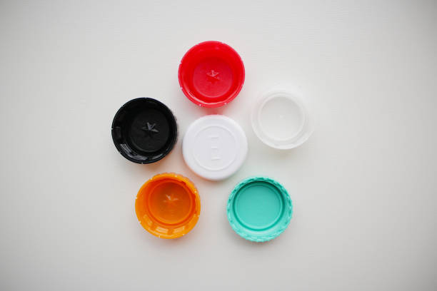istock Top-down view of six color plastic bottle caps on grey background 2146322375
