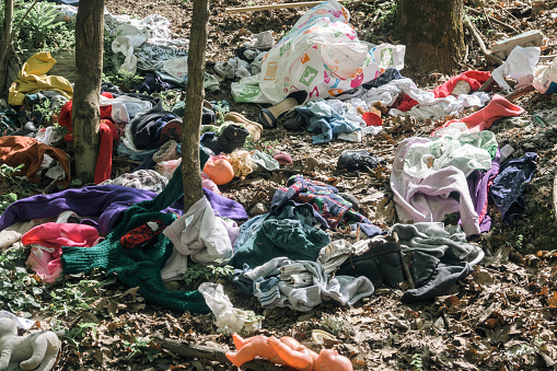 Clothes, shoes, dolls and other garbage in nature. Romania, Gorj. April, 07, 2024
