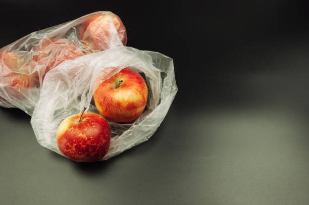 istock A bag of apples is sitting on a black background 2146371109