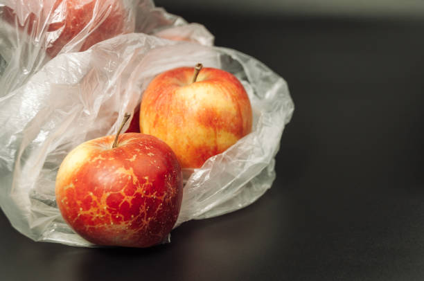 istock Two apples are in a plastic bag on a black background 2146372151