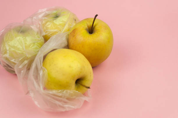istock A bag of apples is sitting on a pink background 2146379851