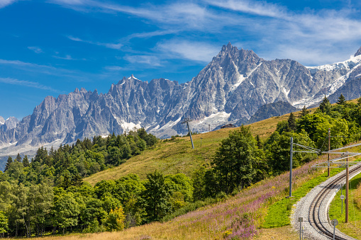 Tour du Montblanc beautiful mountain peaks and green valley. TMB trekking route scenic landscape in french Alps in Chamonix valley alpine scene