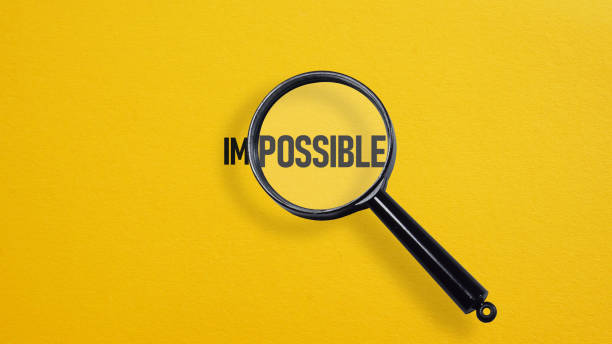 istock Magnifier focuses on the possible side of the word impossible. To make it possible. The concept is nothing impossible. 2146454419