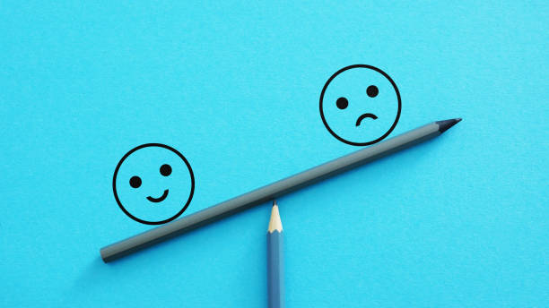 istock Customer satisfaction, evaluation or positive feedback concept. Happy and sad smiley faces on scales 2146454979