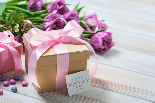Mother's Day concept with craft gift box, candies and tulips. High resolution 42Mp studio digital capture taken with Sony A7rII and Sony FE 90mm f2.8 macro G OSS lens