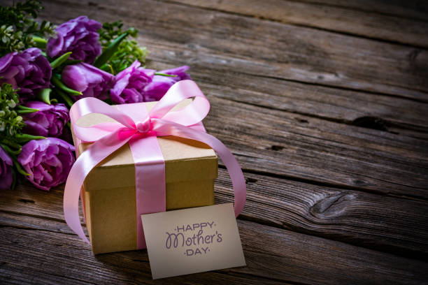 istock Mother's Day concept with tulips and gift box on wooden table. Copy space 2146459066