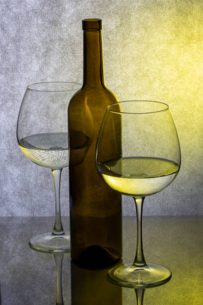 Still life with glassware with liquid on colored background