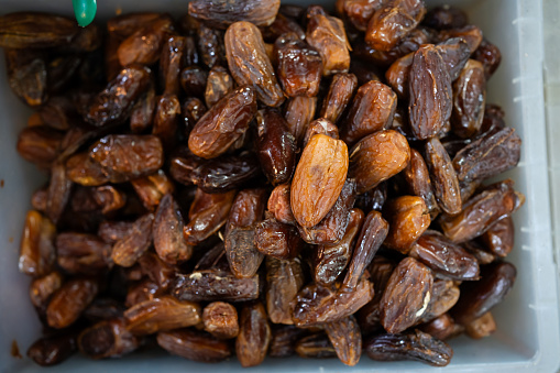 A close-up of dried sweet dates on display at the local market