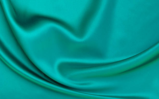 istock Black green satin dark fabric texture luxurious shiny that is abstract silk cloth background with patterns soft waves blur beautiful. 2146531841
