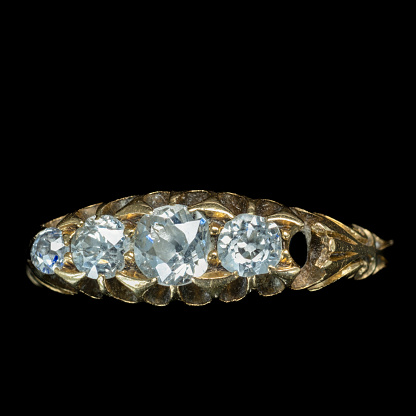 Antique five diamond cluster ring with one of the inlaid stones missing and displayed against a black background. A good image for a jeweller or jewellery repairer.