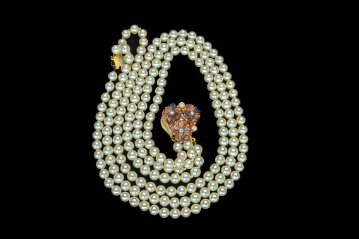 Antique pearl necklace in white pearl chain with a plum coloured floral clasp.