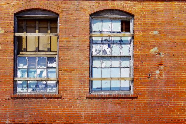 istock Shattered windows in an old brick building 2146547467